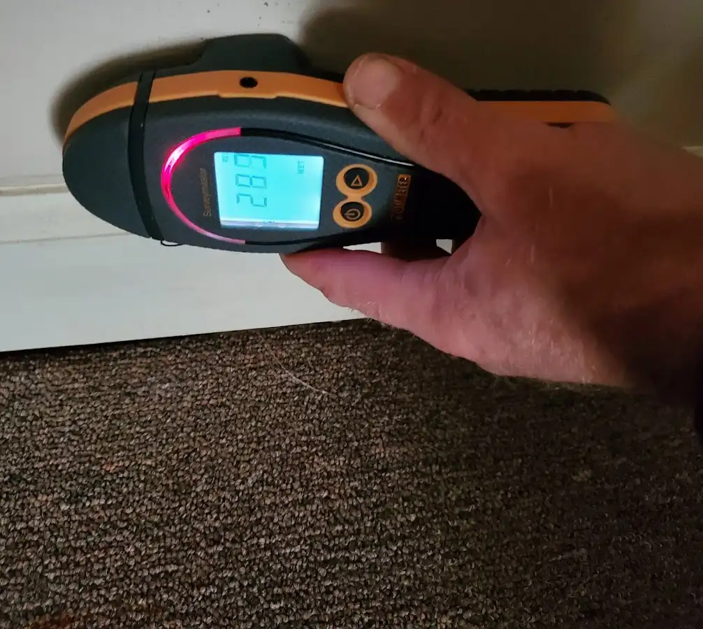 Moisture detection at baseboard during Storm Damage Restoration in Roanoke